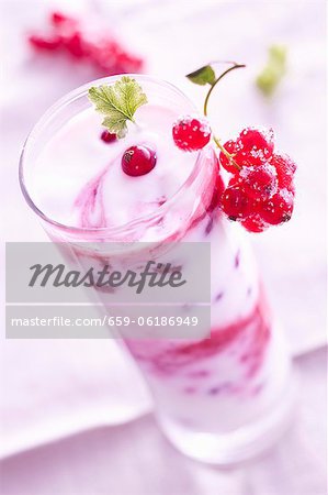 A layered yogurt dessert with redcurrants
