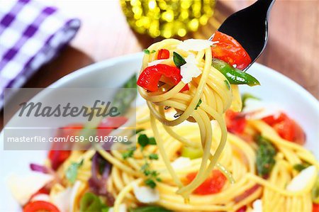 Spaghetti with vegetables on a fork