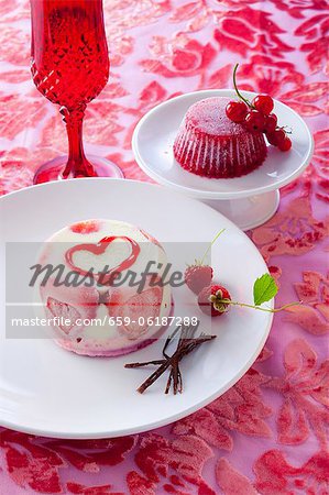 An ice cream tart with strawberries and frozen jelly with redcurrants