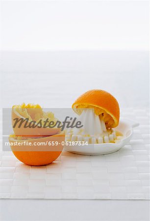 Squeezed oranges and citrus squeezer