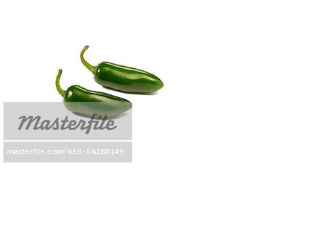 Two Whole Jalapenos in a White Background