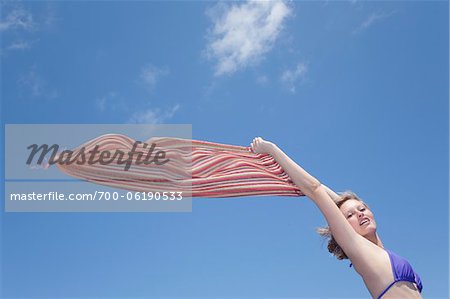 Teenage Girl Holding Scarf Out in Wind