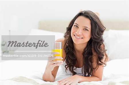Attractive brunette with an orange juice