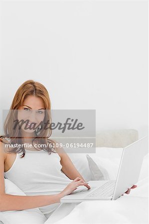 Portrait of a redheaded woman using a laptop