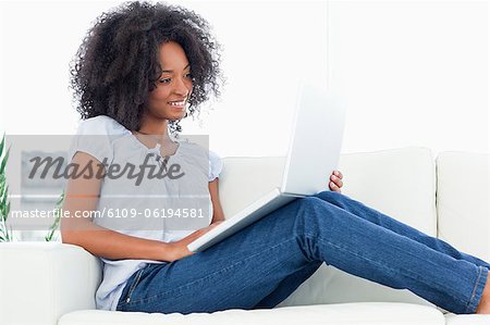 Smiling fuzzy hair woman with a smartphone