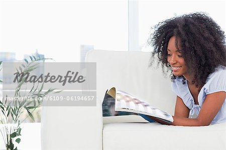 Smiling woman holding a magazine