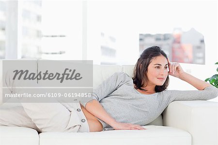Smiling brunette on her sofa