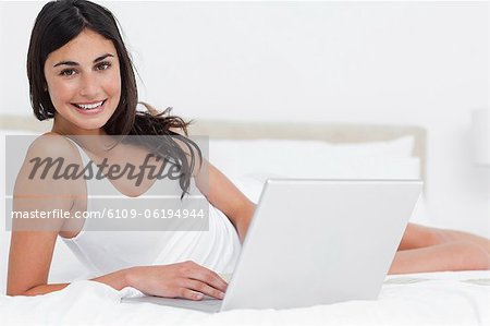 Portrait of a brunette using her laptop