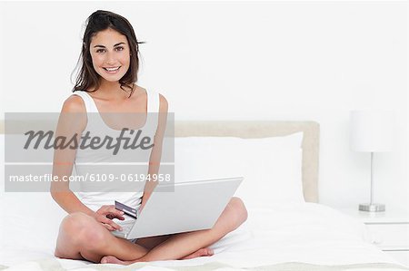 Portrait of a brunette a laptop on knees sholpping online