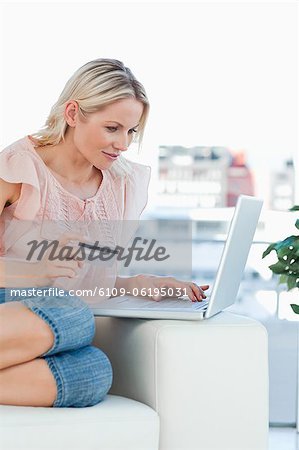 Blonde buying online with a laptop