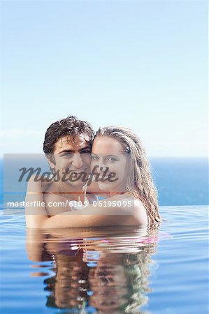 Smiling couple embracing in the pool