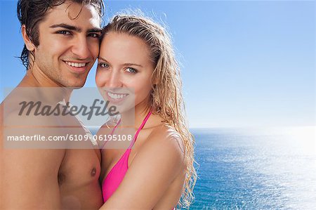 Smiling couple standing in the pool together