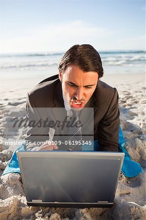 Young businessman typing on his laptop