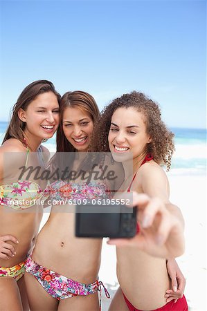 Three friends smiling as they pose for a photo
