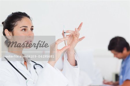 Doctor preparing a syringe