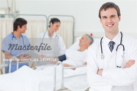 Smiling doctor with his arms crossed