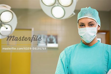 Serious nurse wearing surgical clothes