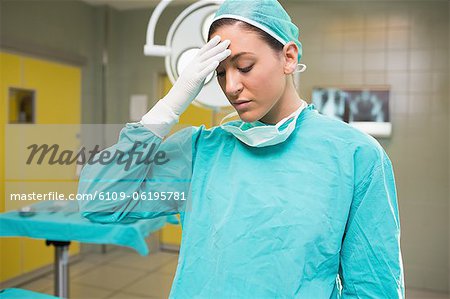 Nurse tired with hand on her forehead