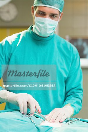 Close up of a serious surgeon looking at camera