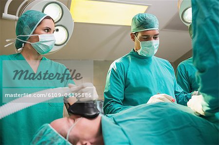 Krankenschwester hält eine Maske beim Betrachten der Chirurg