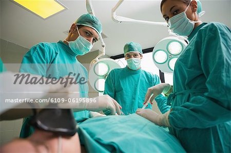 Low view of a surgical team looking at camera