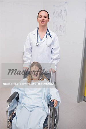 Smiling doctor with a girl in a wheelchair