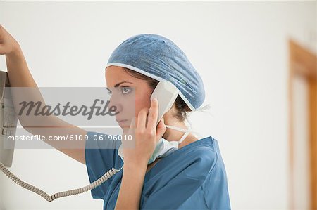 Surgeon using a phone in a hallway