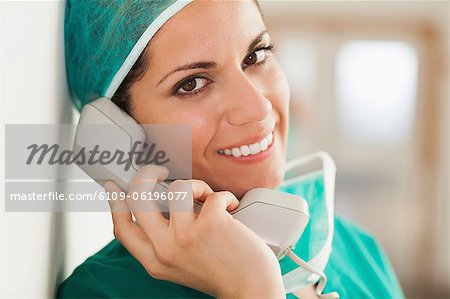 Woman surgeon on the phone in a hallway