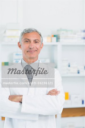 Pharmacist with his arms crossed standing in a pharmacy