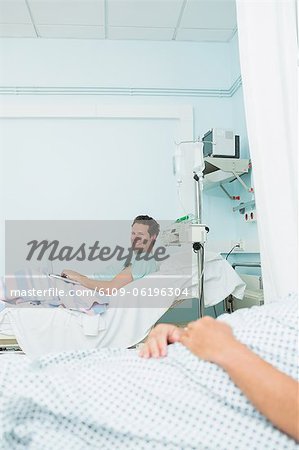 Smiling patient in a hospital room with an other patient