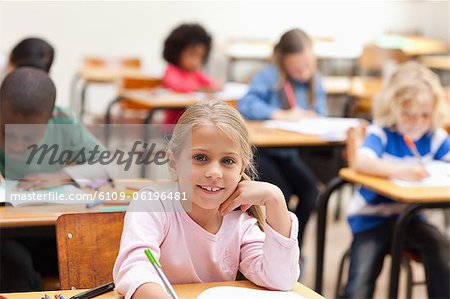 Smiling girl sitting in the classroom
