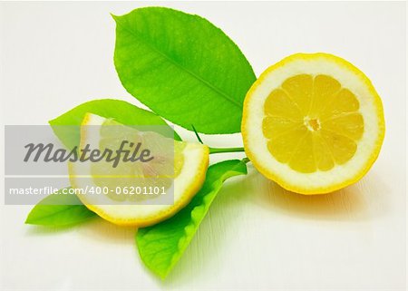 Lemon cut into slices and green leaves
