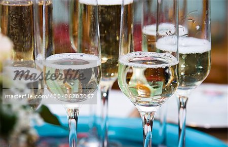 Golden champagne sparkle with fluted glasses and party ribbons