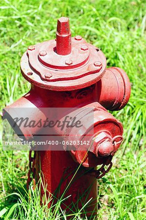 A red Fire Hydrant on the green grassland