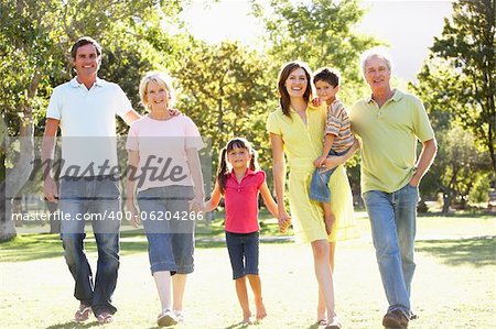 Extended Group Portrait Of Family Enjoying Walk In Park