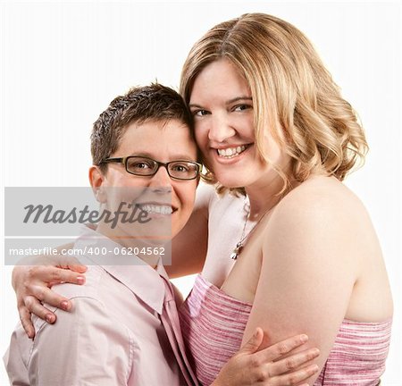 Two happy friends embrace over white background