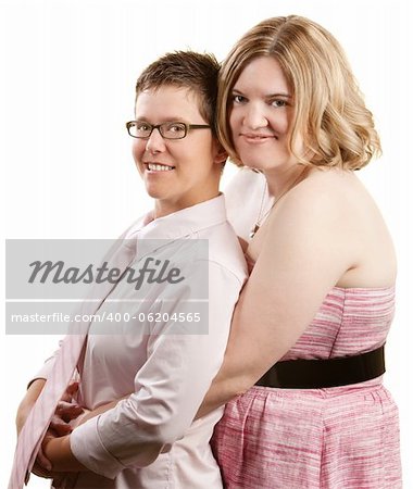 Caucasian lesbian couple embracing over white background