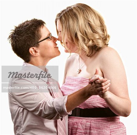 Two lesbian women dancing together over white background