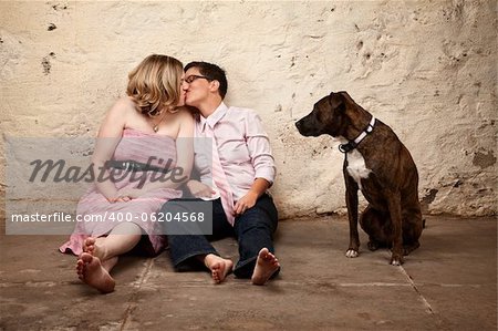 Lesbian kissing couple on floor with pet dog watching
