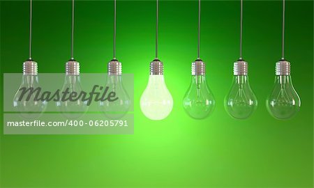 Seven light bulbs with lit one on green background
