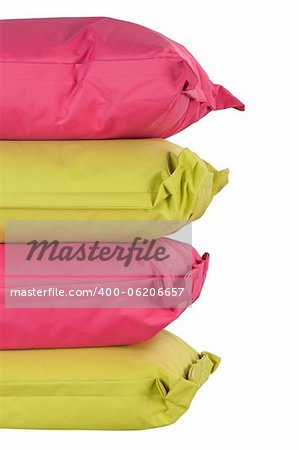 bright stack of pink and green pillows isolated on white
