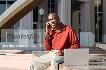 Man with Laptop and Cell Phone