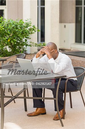 Businessman with Head in Hands