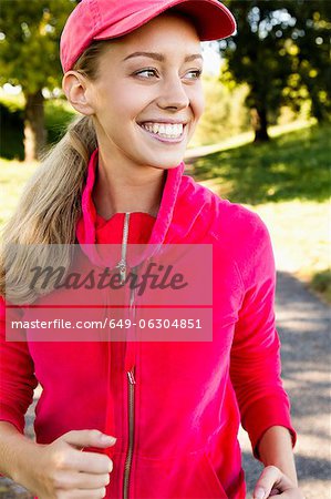 Smiling woman jogging outdoors