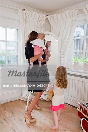 Mother and children in front of mirror