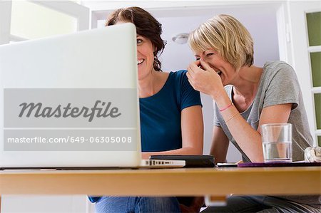 Women using laptop together