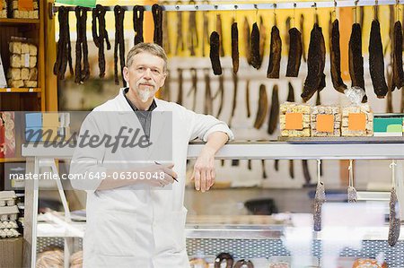 Butcher standing at meat counter