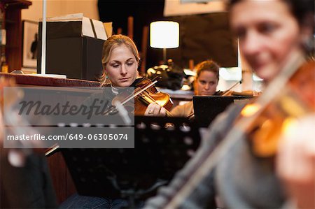 Violin player practicing with group
