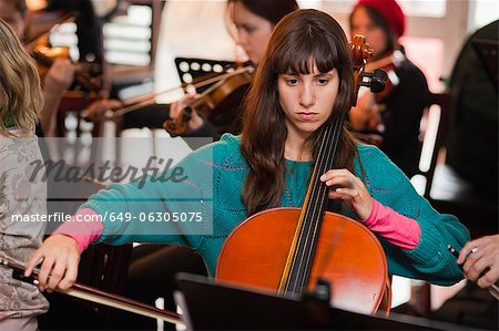 Cello player practicing with group