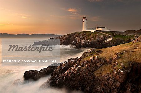 Lighthouse on foggy coastline